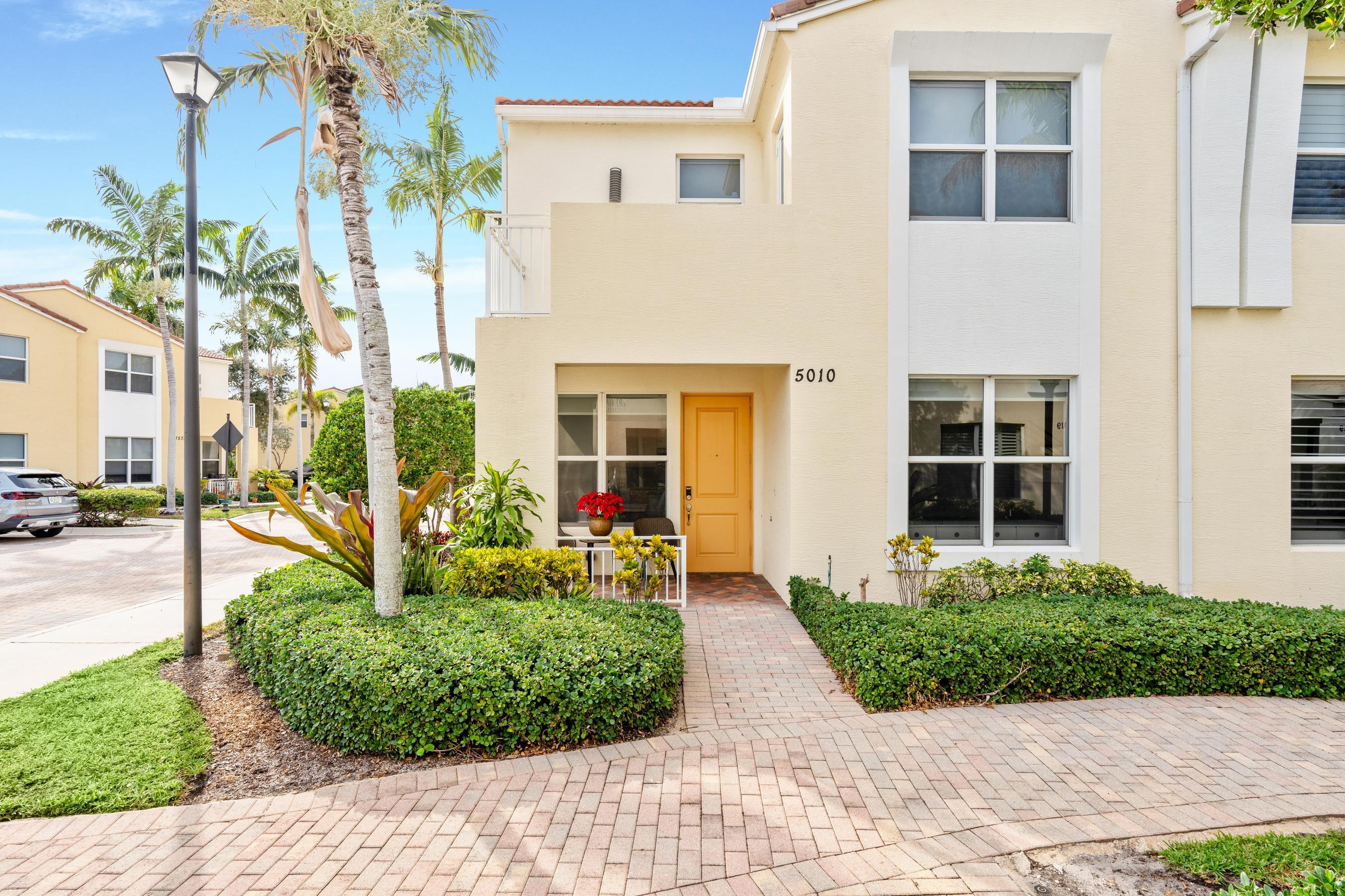 5010 Northwest 16th Way Boca Raton, FL 33431 - Photo 1 of 42 a front view of a house with garden and plants