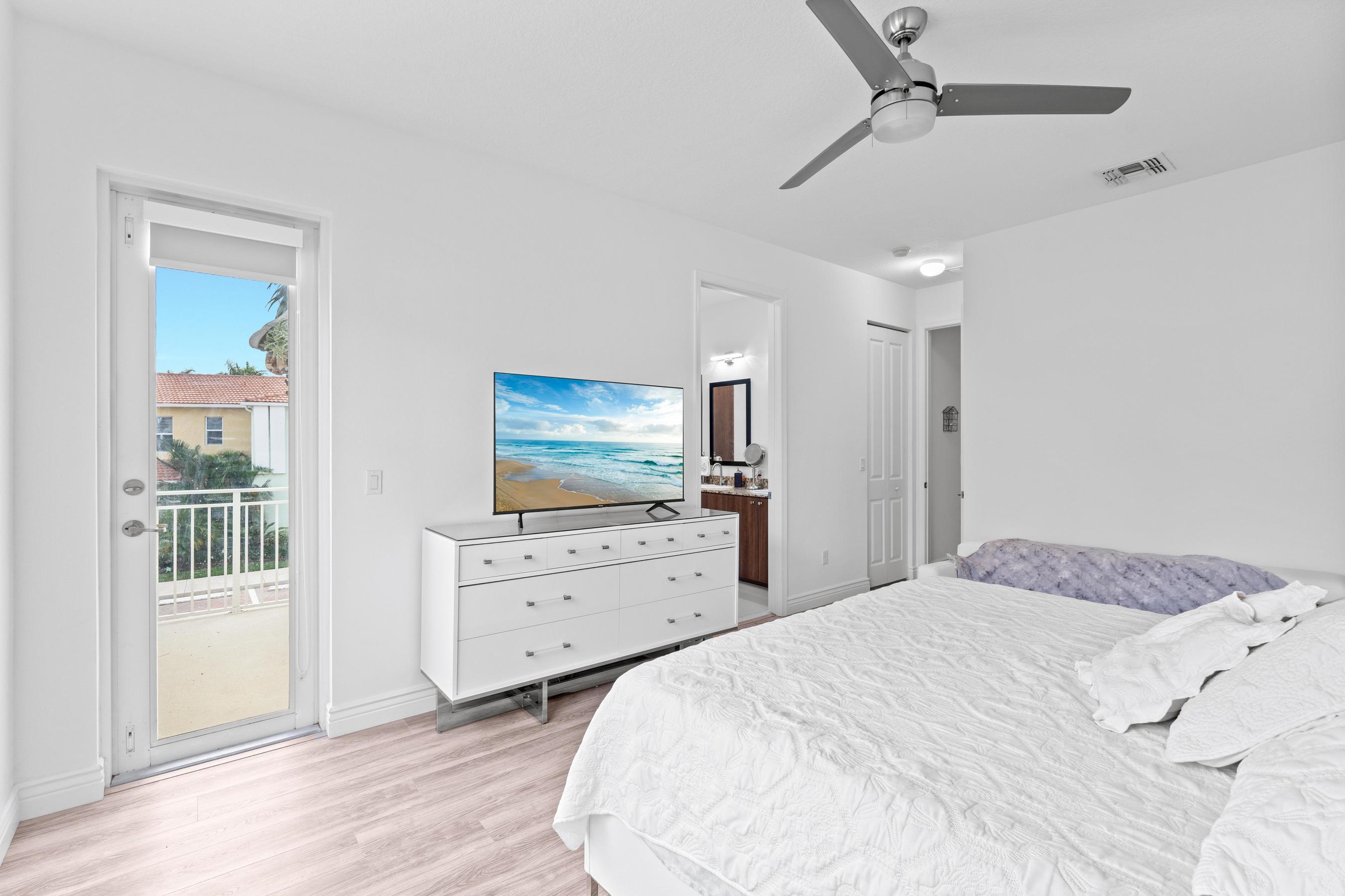 5010 Northwest 16th Way Boca Raton, FL 33431 - Photo 12 of 42 a bedroom with a bed and a flat screen tv