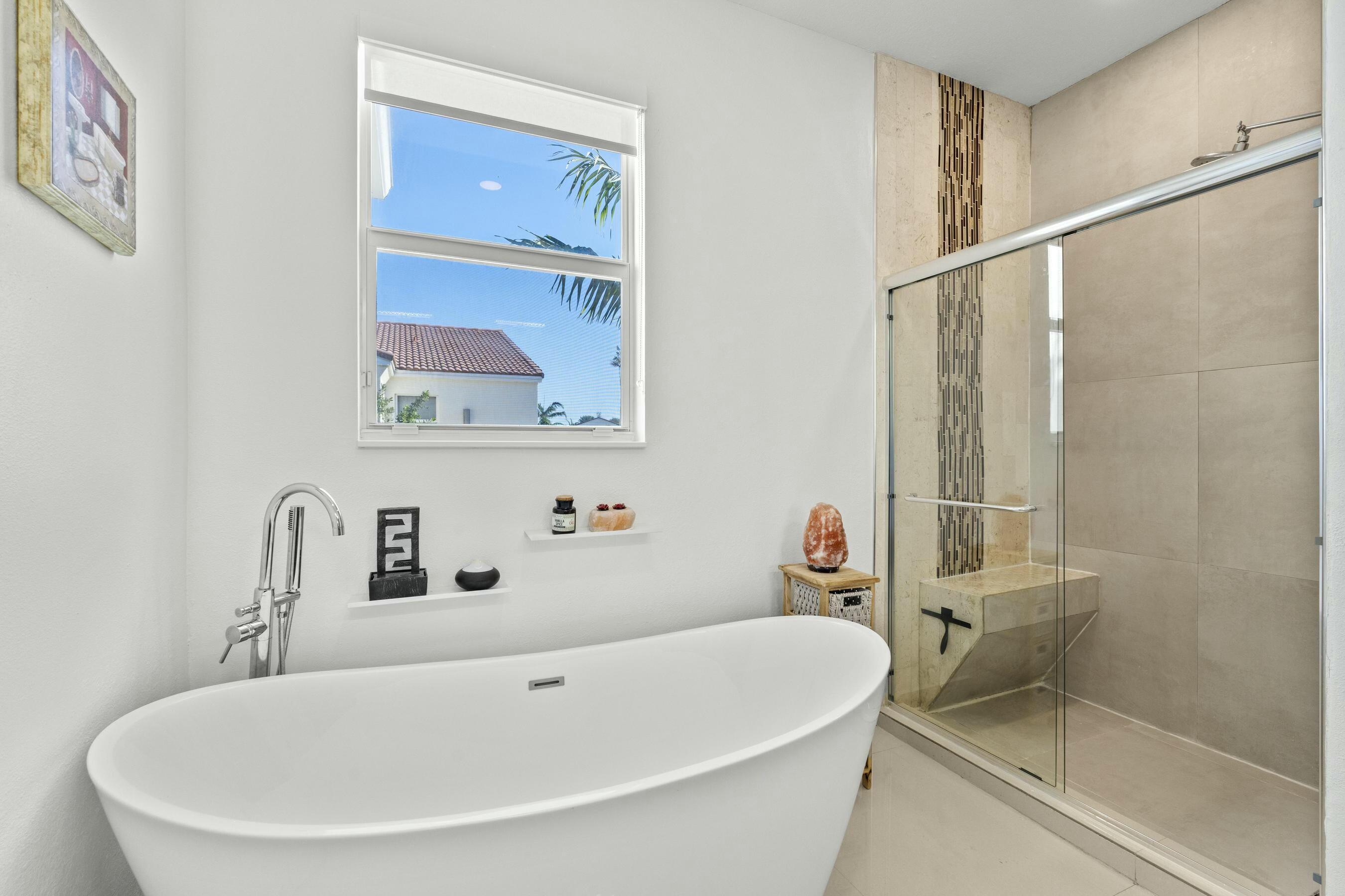 5010 Northwest 16th Way Boca Raton, FL 33431 - Photo 18 of 42 a bathroom with a tub and sink