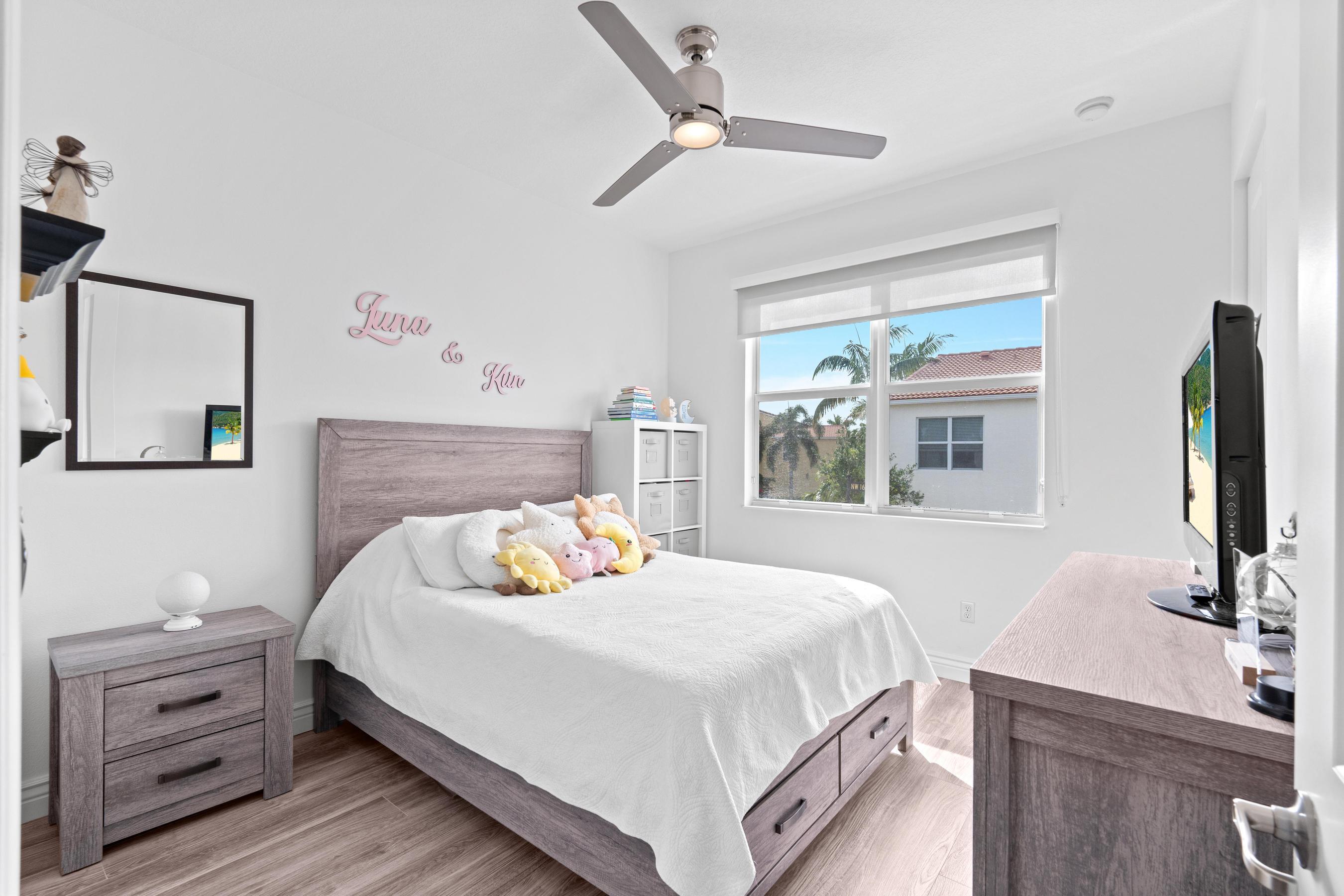 5010 Northwest 16th Way Boca Raton, FL 33431 - Photo 22 of 42 a bedroom with a bed and a flat tv screen on dresser