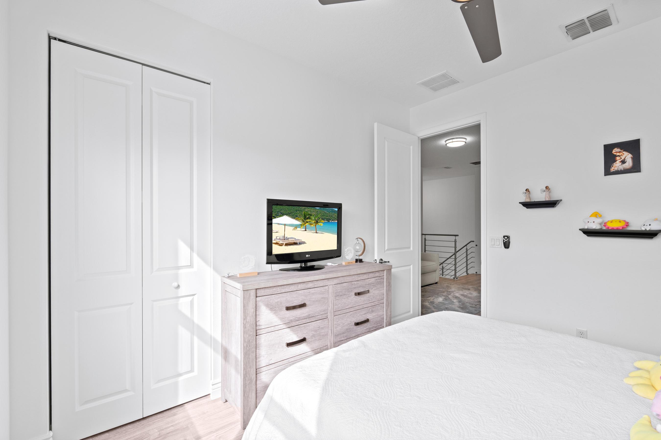 5010 Northwest 16th Way Boca Raton, FL 33431 - Photo 23 of 42 a bedroom with a bed and a flat screen tv