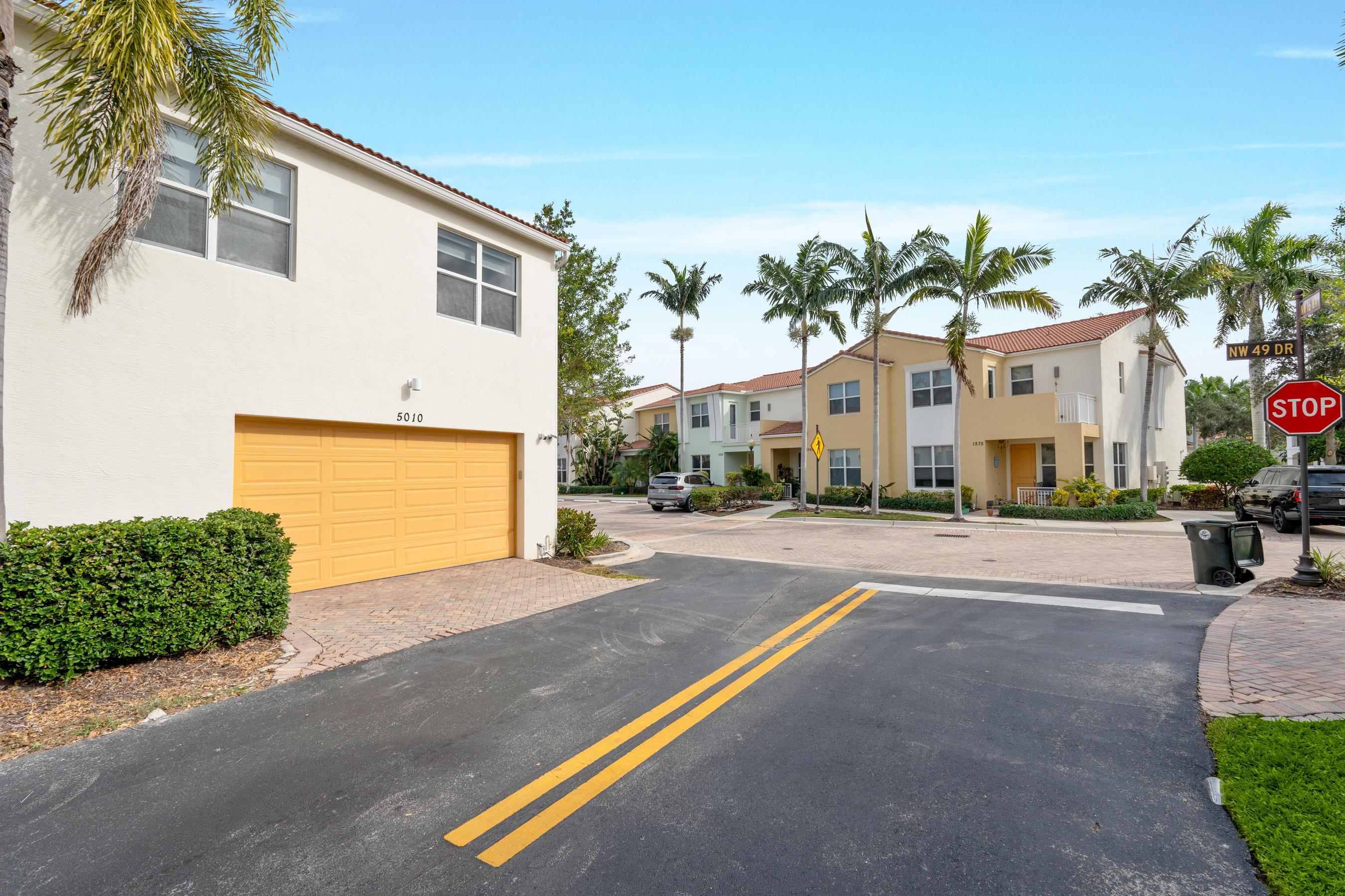 5010 Northwest 16th Way Boca Raton, FL 33431 - Photo 33 of 42 a front view of a house with a yard and a garage