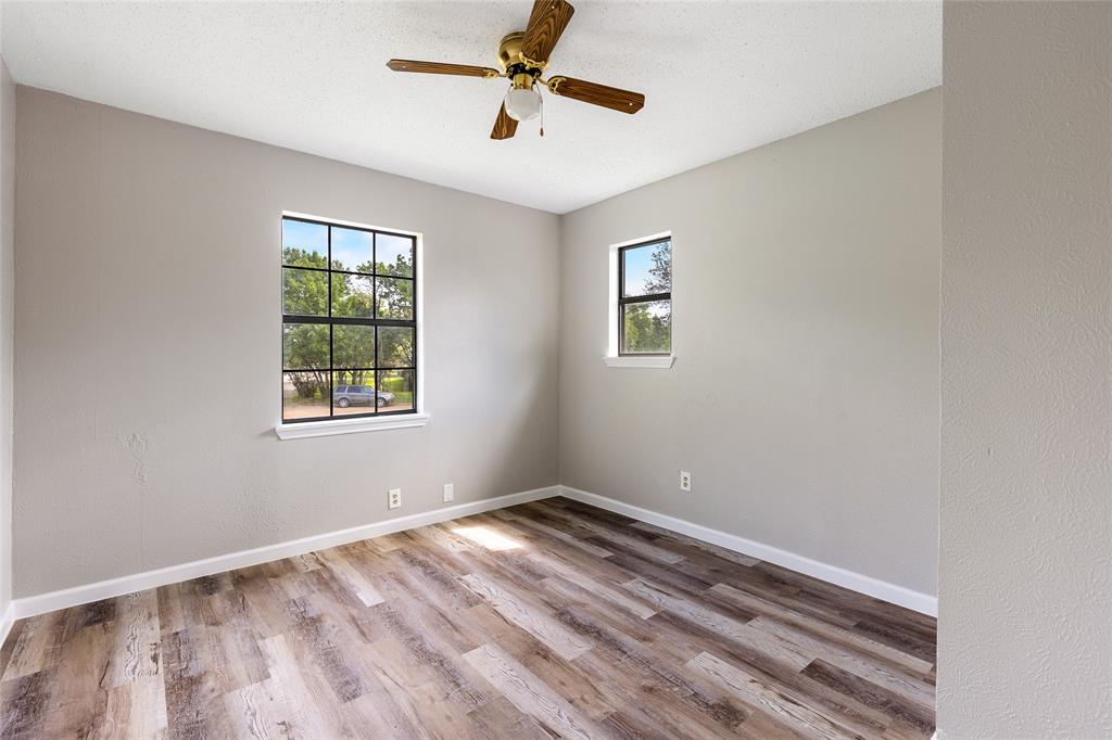 2820 Bois D'Arc Street Commerce, TX 75428 - Photo 19 of 40 wooden floor in an empty room with a window