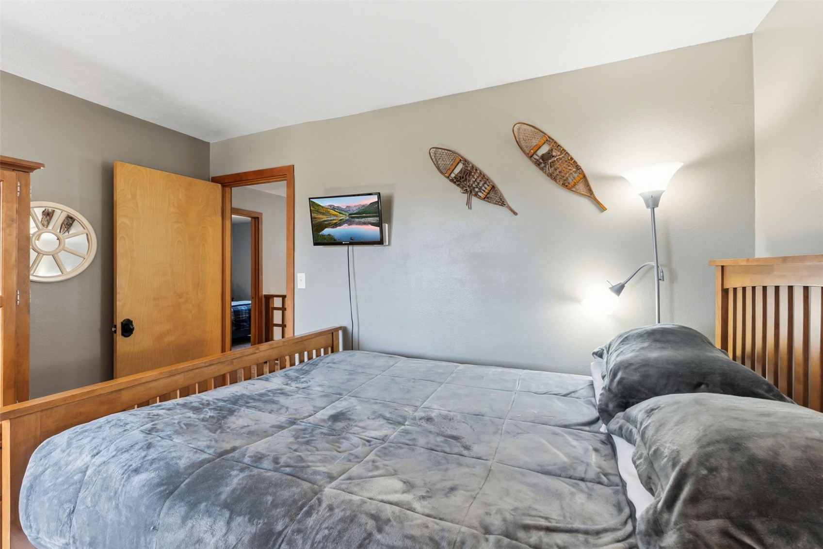 6734 Ryan Gulch Road, Unit 6734 Silverthorne, CO 80498 - Photo 21 of 33 a bedroom with a bed and wooden floor