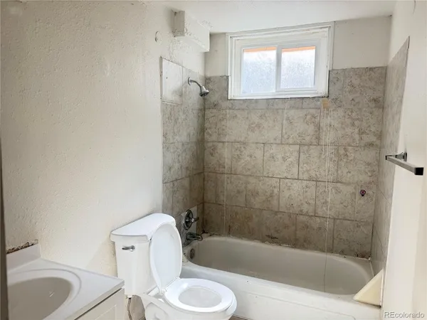 a bathroom with a toilet bathtub and sink