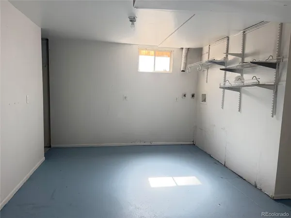 a view of a room with wooden floor and electronic appliances