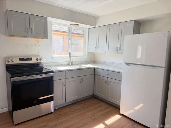a kitchen with a stove sink and refrigerator