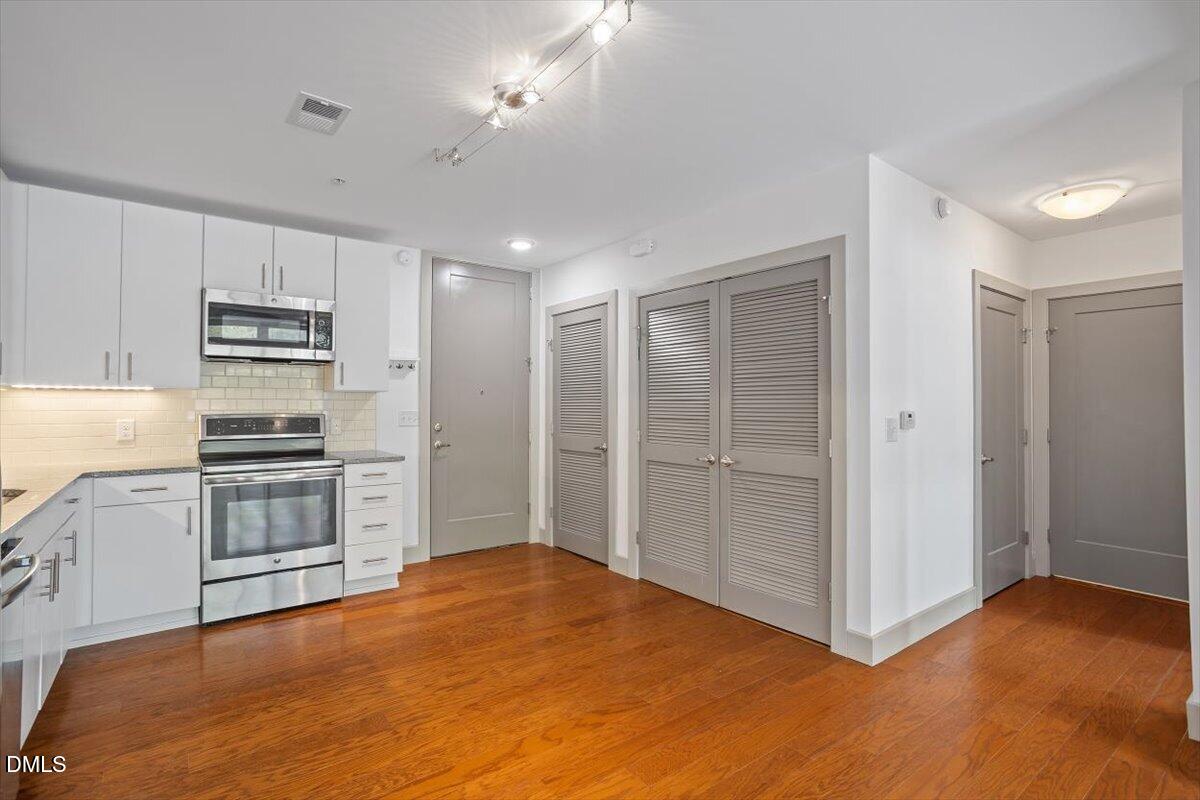 1300 St Marys Street, Unit 207 Raleigh, NC 27605 - Photo 4 of 31 a kitchen with a refrigerator oven and a stove