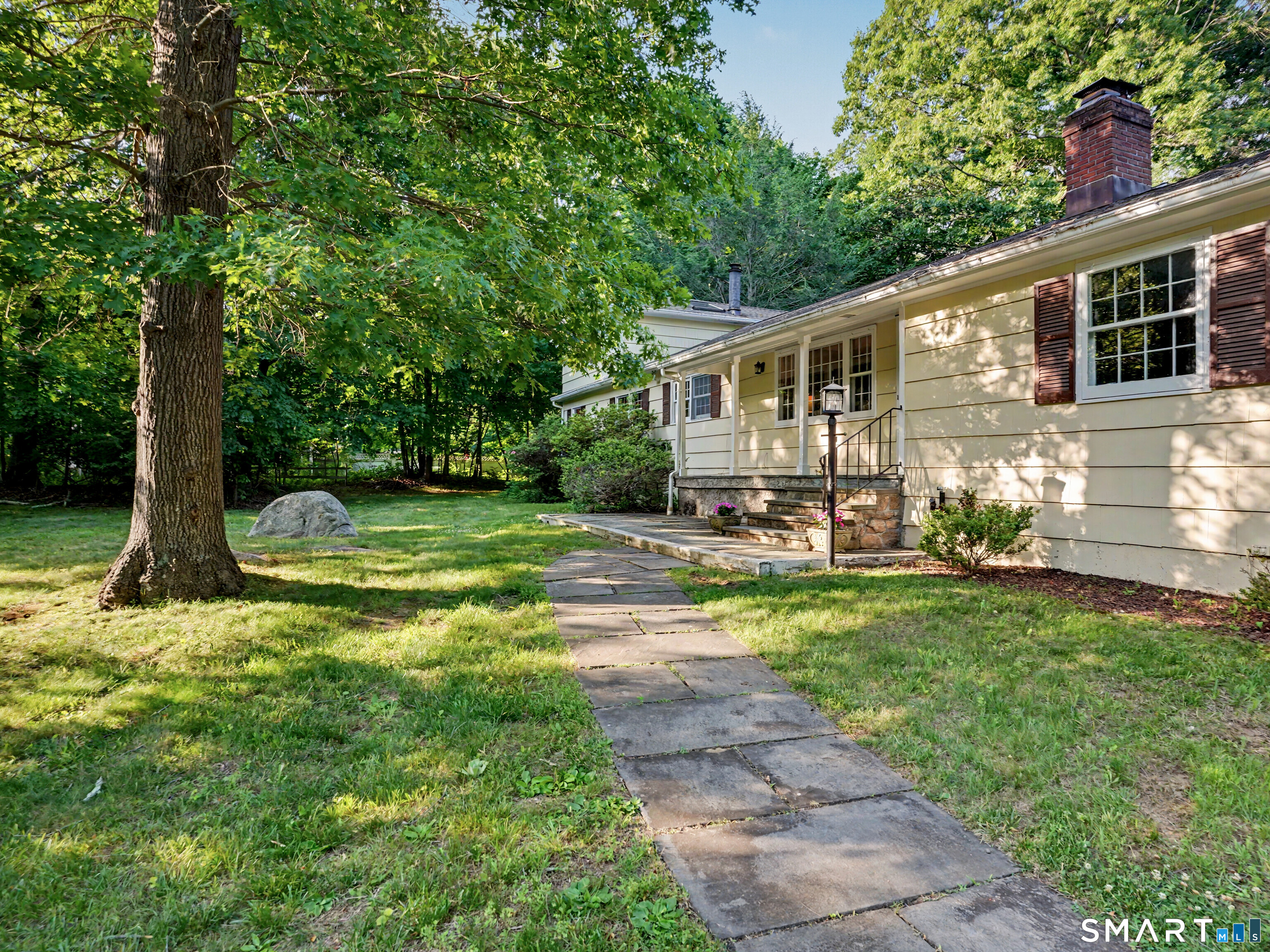 15 Flat Rock Drive Ridgefield, CT 06877 - Photo 2 of 39 a view of a house with backyard and sitting area
