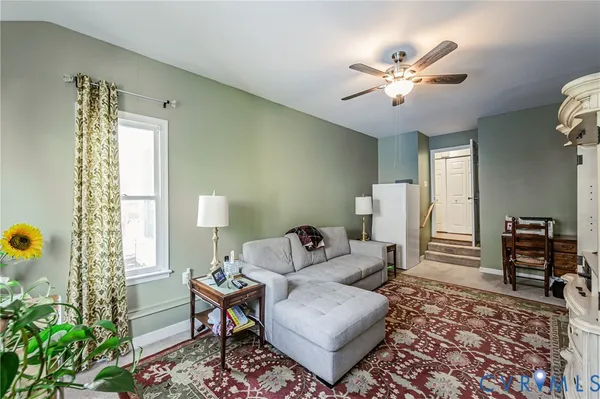 a living room with furniture and wooden floor