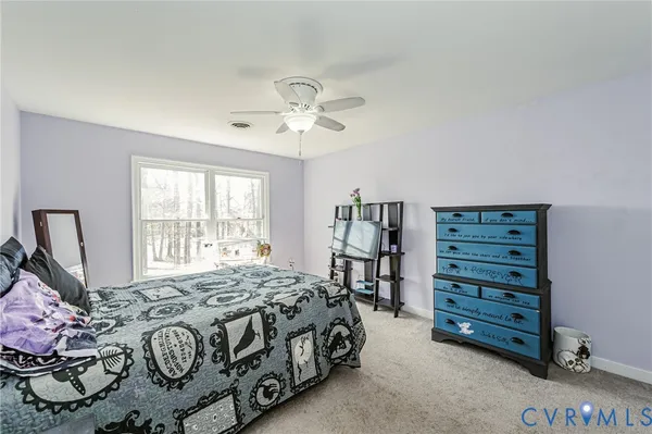 a bedroom with a bed a dresser and a window