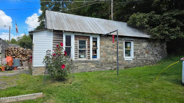 a room with water heater and wooden cabinets