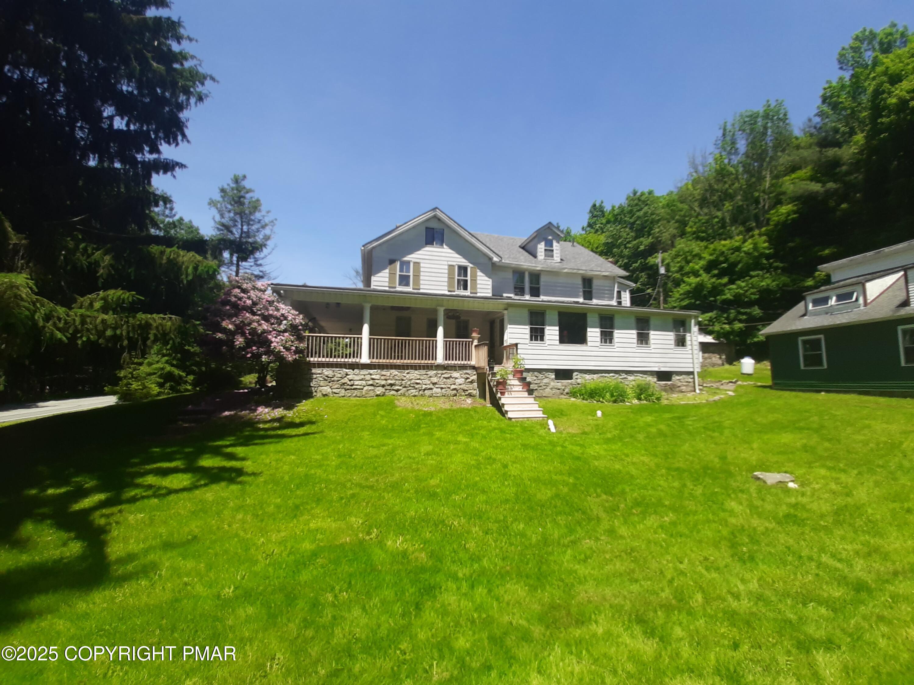 394 Highway 447 Newfoundland, PA 18445 - Photo 15 of 50 a front view of a house with a garden