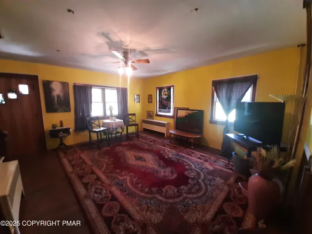 a kitchen with stainless steel appliances kitchen island granite countertop a table chairs and a refrigerator