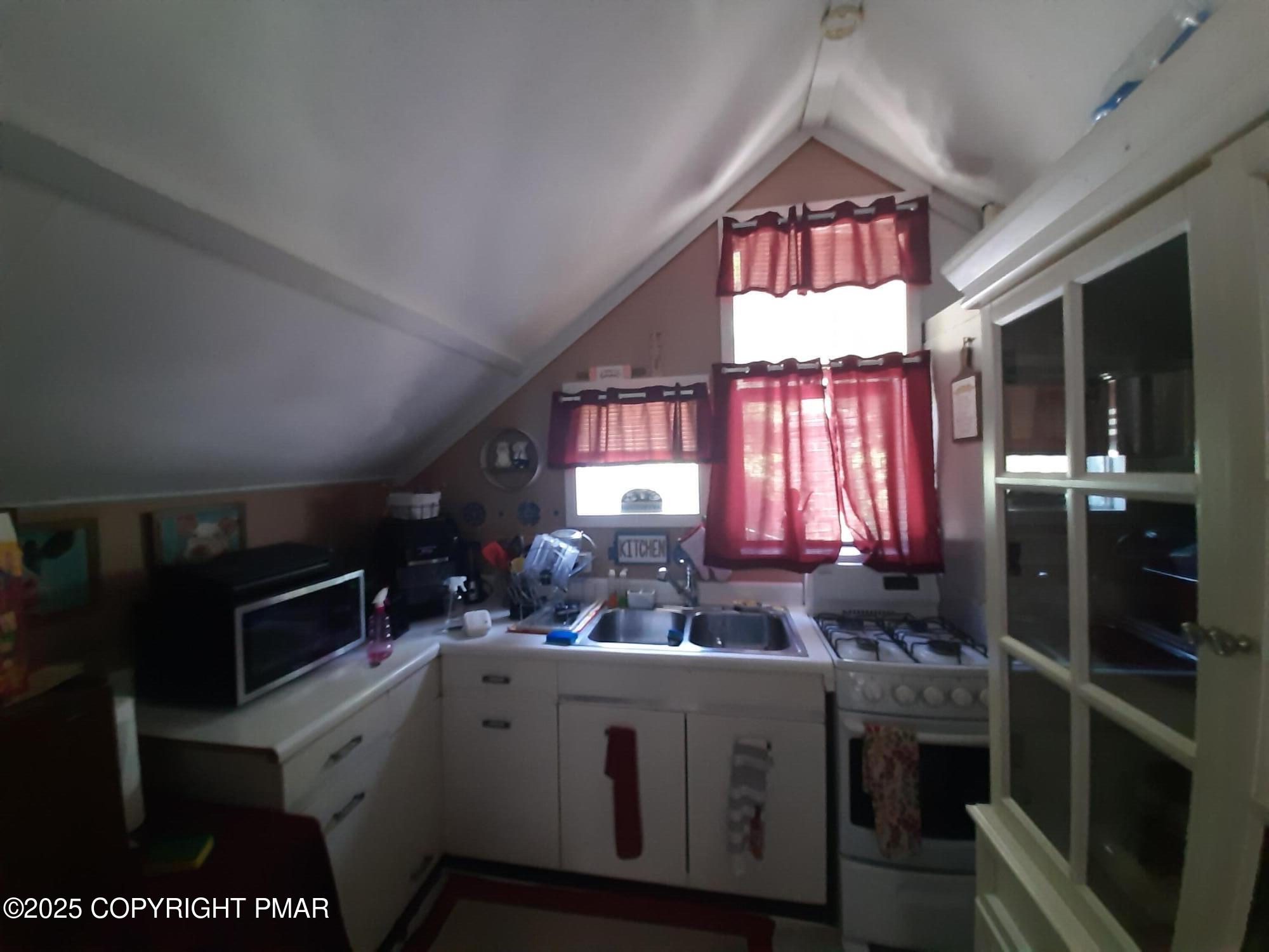 394 Highway 447 Newfoundland, PA 18445 - Photo 23 of 50 a kitchen with kitchen island granite countertop a stove a sink and a refrigerator