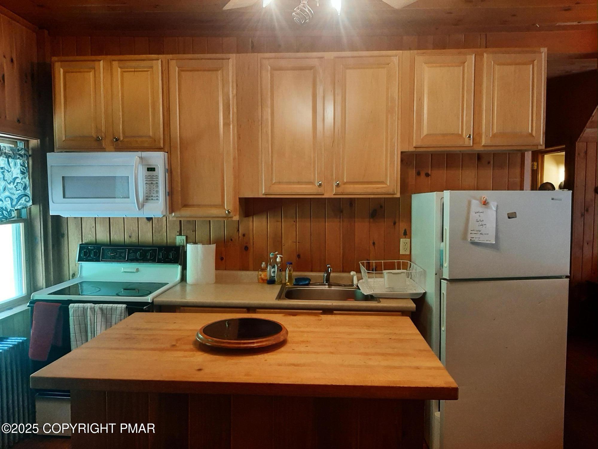 394 Highway 447 Newfoundland, PA 18445 - Photo 33 of 50 a kitchen with kitchen island granite countertop a sink a stove and a refrigerator