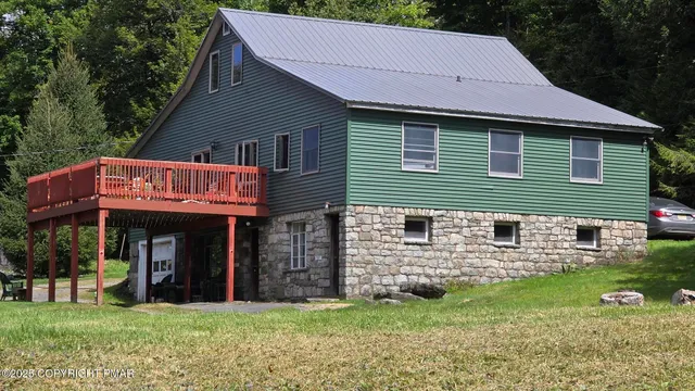 a yellow building in the middle of a field