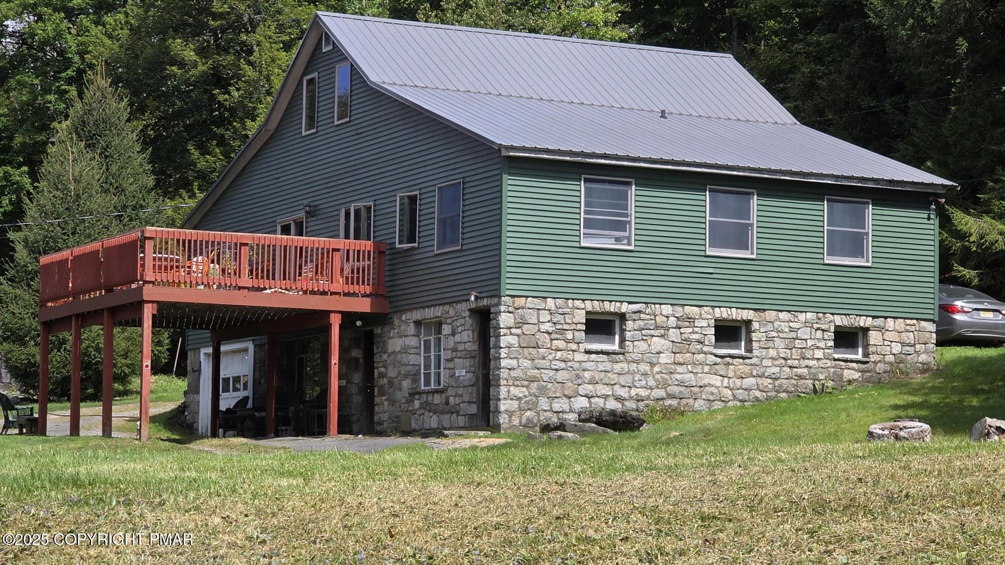 394 Highway 447 Newfoundland, PA 18445 - Photo 4 of 50 a view of a house with a yard and a garden
