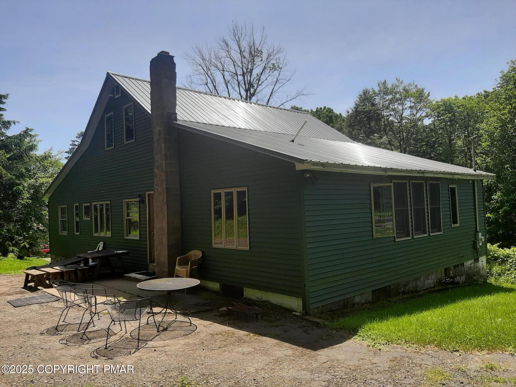 394 Highway 447 Newfoundland, PA 18445 - Photo 6 of 50 a front view of a house with garden