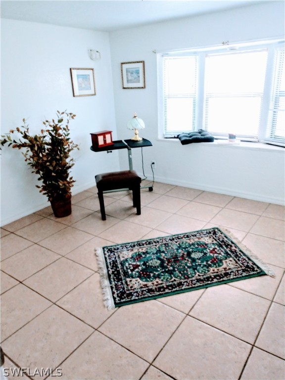 7351 Pinehurst Road Bokeelia, FL 33922 - Photo 24 of 31 a living room with a rug and a potted plant