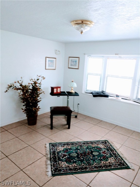 7351 Pinehurst Road Bokeelia, FL 33922 - Photo 25 of 31 a living room with furniture and flowers