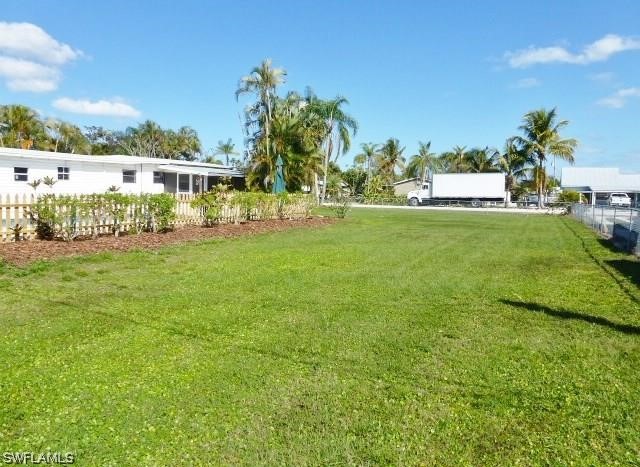 7351 Pinehurst Road Bokeelia, FL 33922 - Photo 3 of 31 a view of a garden with a building in the background