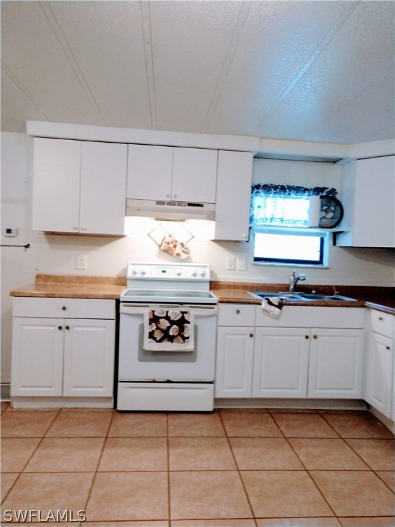 7351 Pinehurst Road Bokeelia, FL 33922 - Photo 8 of 31 a kitchen with cabinets and appliances