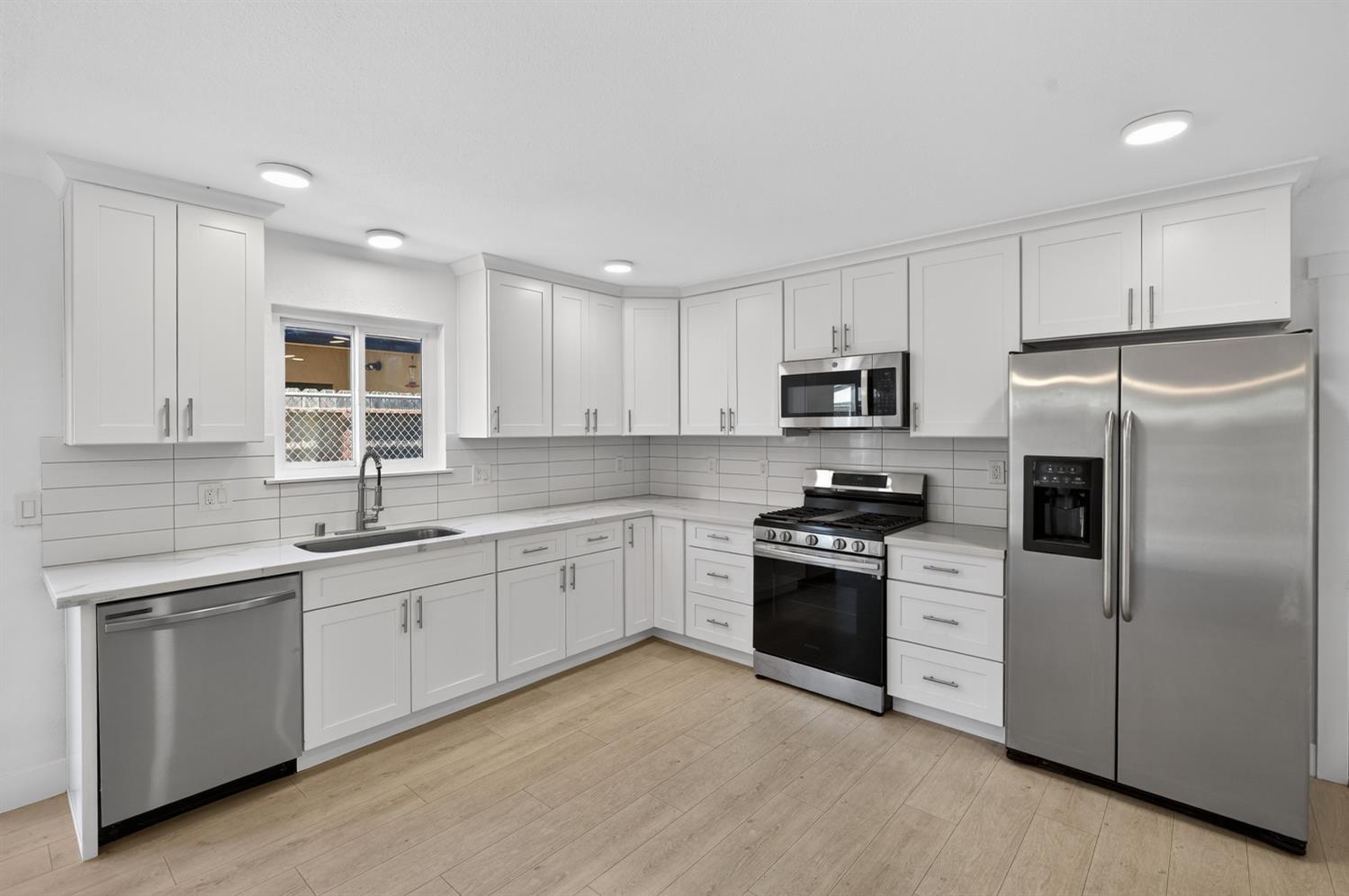 10457 Rockingham Drive Rancho Cordova, CA 95670 - Photo 16 of 49 a kitchen with cabinets stainless steel appliances and sink