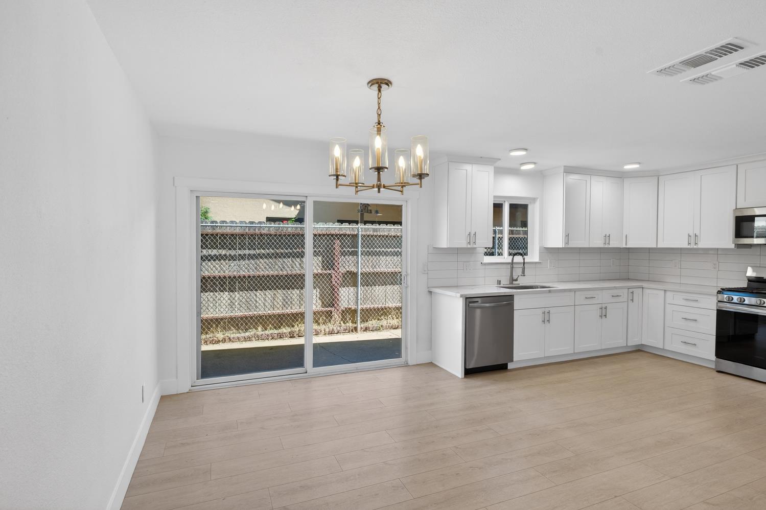10457 Rockingham Drive Rancho Cordova, CA 95670 - Photo 20 of 49 a large kitchen with a large window and cabinets