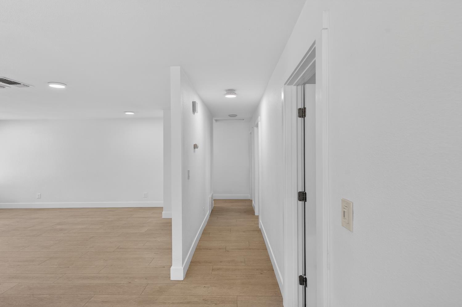 10457 Rockingham Drive Rancho Cordova, CA 95670 - Photo 21 of 49 a view of a hallway with wooden floor and a bathroom