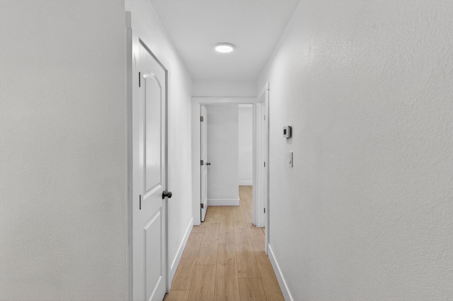 10457 Rockingham Drive Rancho Cordova, CA 95670 - Photo 29 of 49 a view of a hallway with wooden floor and a bathroom