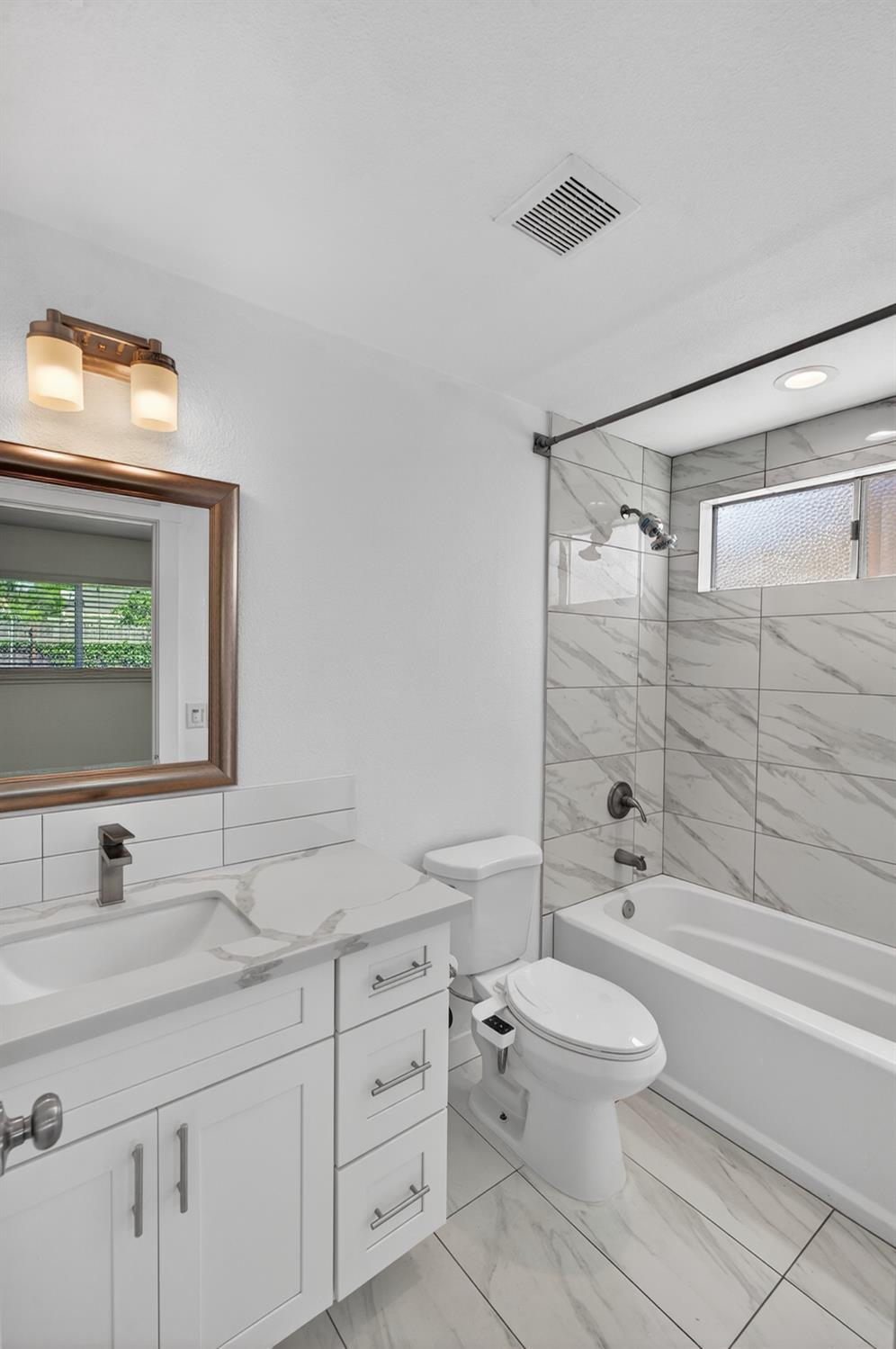 10457 Rockingham Drive Rancho Cordova, CA 95670 - Photo 30 of 49 a bathroom with a granite countertop toilet sink and a mirror