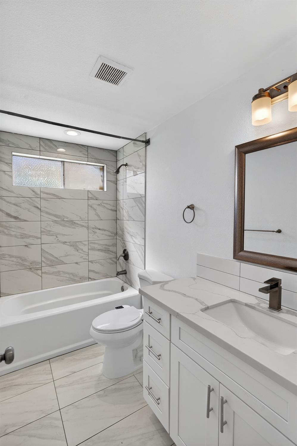 10457 Rockingham Drive Rancho Cordova, CA 95670 - Photo 32 of 49 a bathroom with a granite countertop sink a toilet and shower