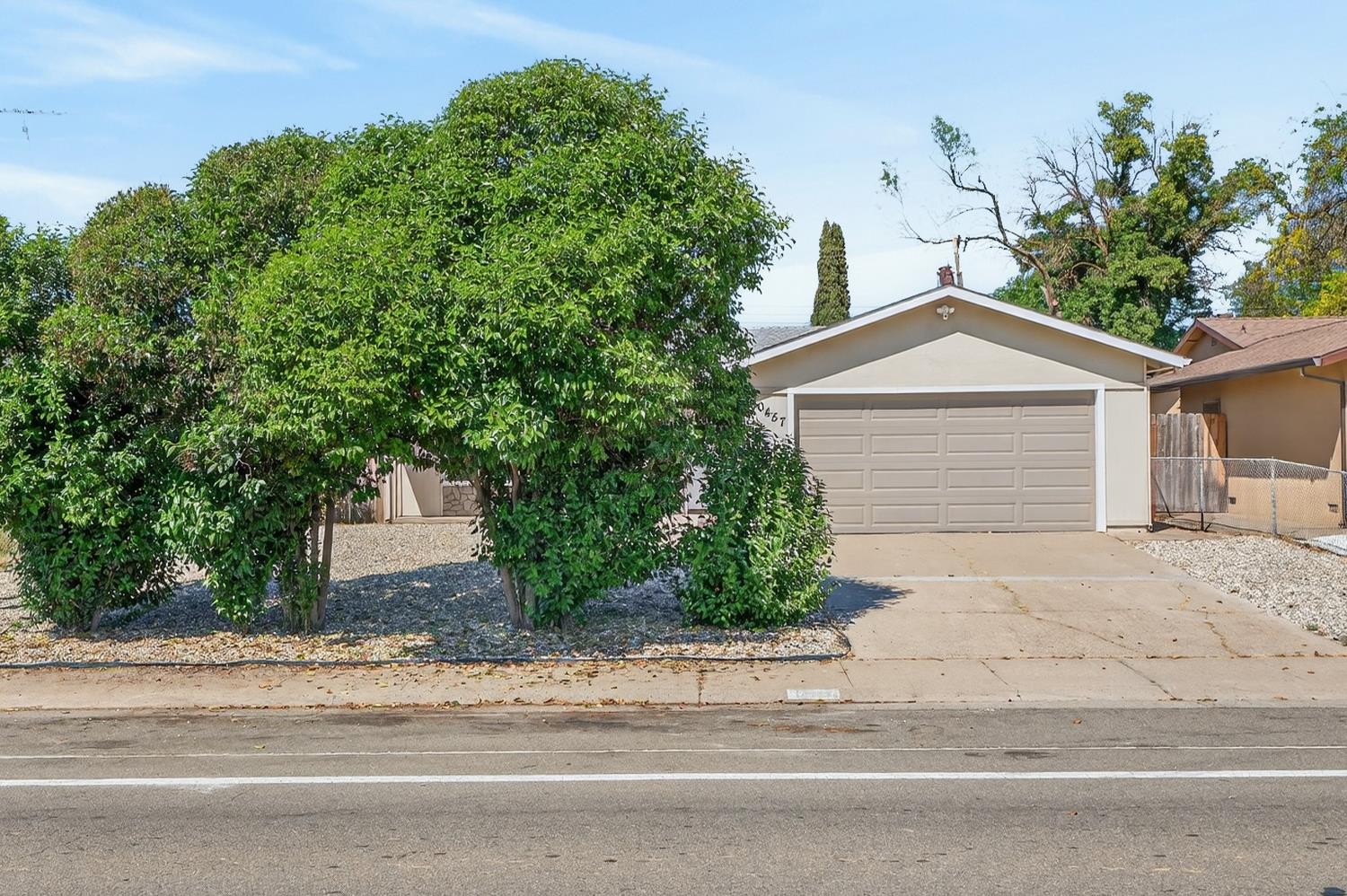 10457 Rockingham Drive Rancho Cordova, CA 95670 - Photo 9 of 49 a front view of a house with a yard and garage