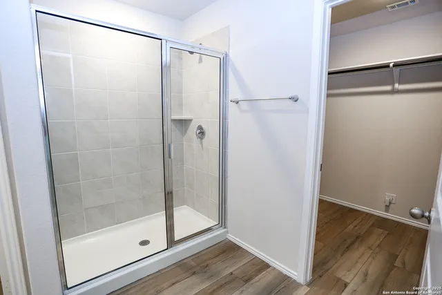 a bathroom with a glass shower door