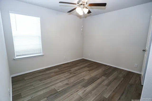 wooden floor in an empty room with a window