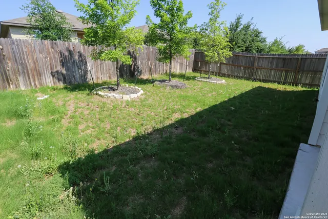 a view of a backyard with a fence