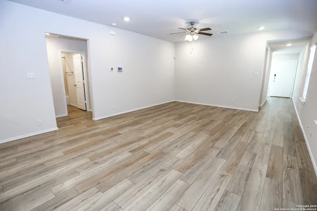 wooden floor in an empty room with a window