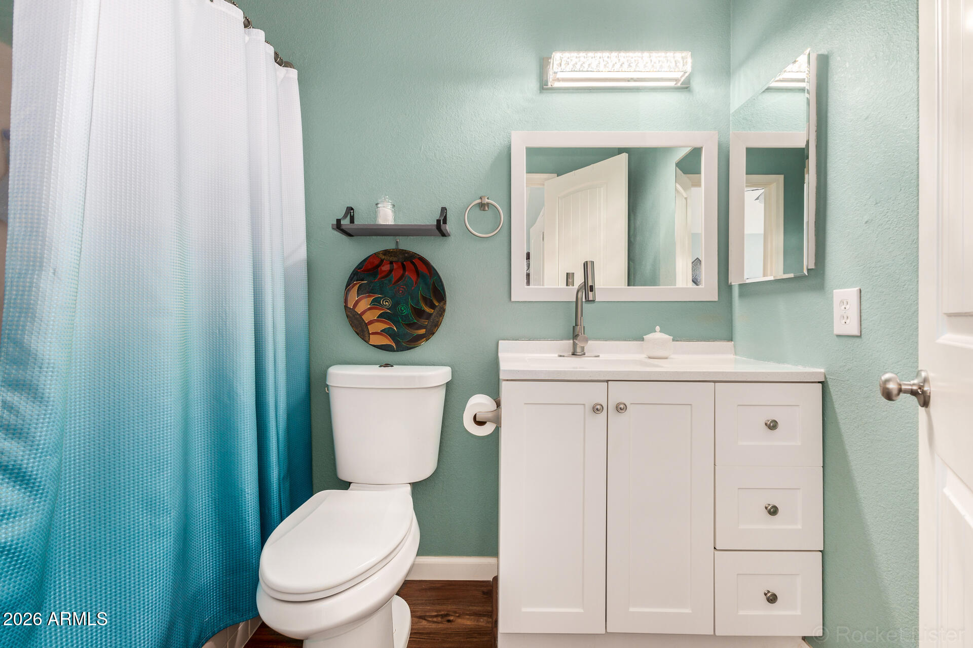 5808 East Brown Road, Unit 143 Mesa, AZ 85205 - Photo 11 of 22 a bathroom with a toilet a sink a vanity and mirror