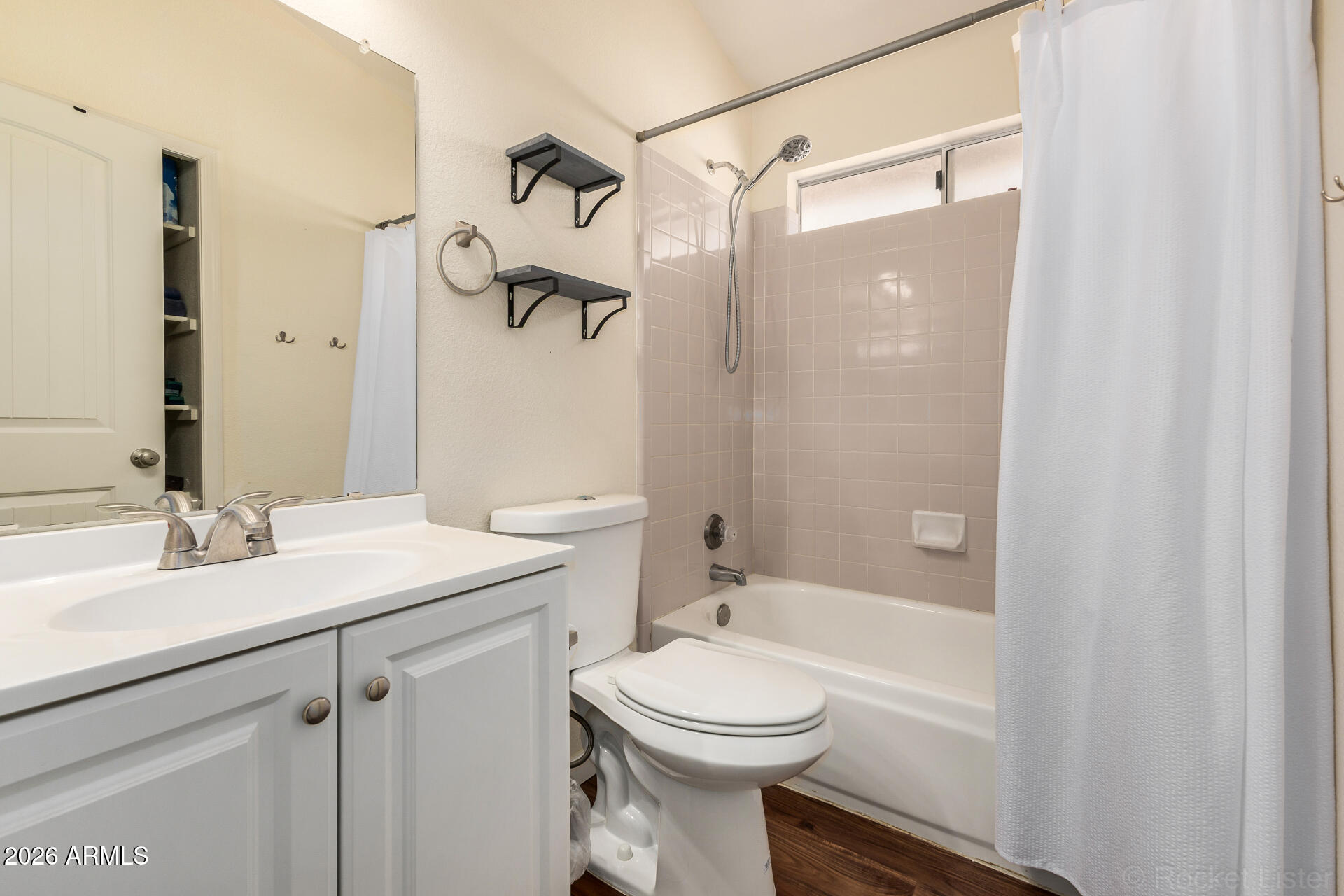 5808 East Brown Road, Unit 143 Mesa, AZ 85205 - Photo 16 of 22 a bathroom with a sink a toilet and shower