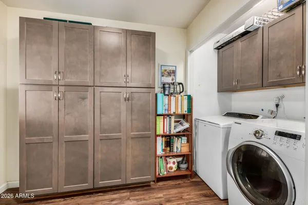 a view of a storage & utility room with closet wooden floor
