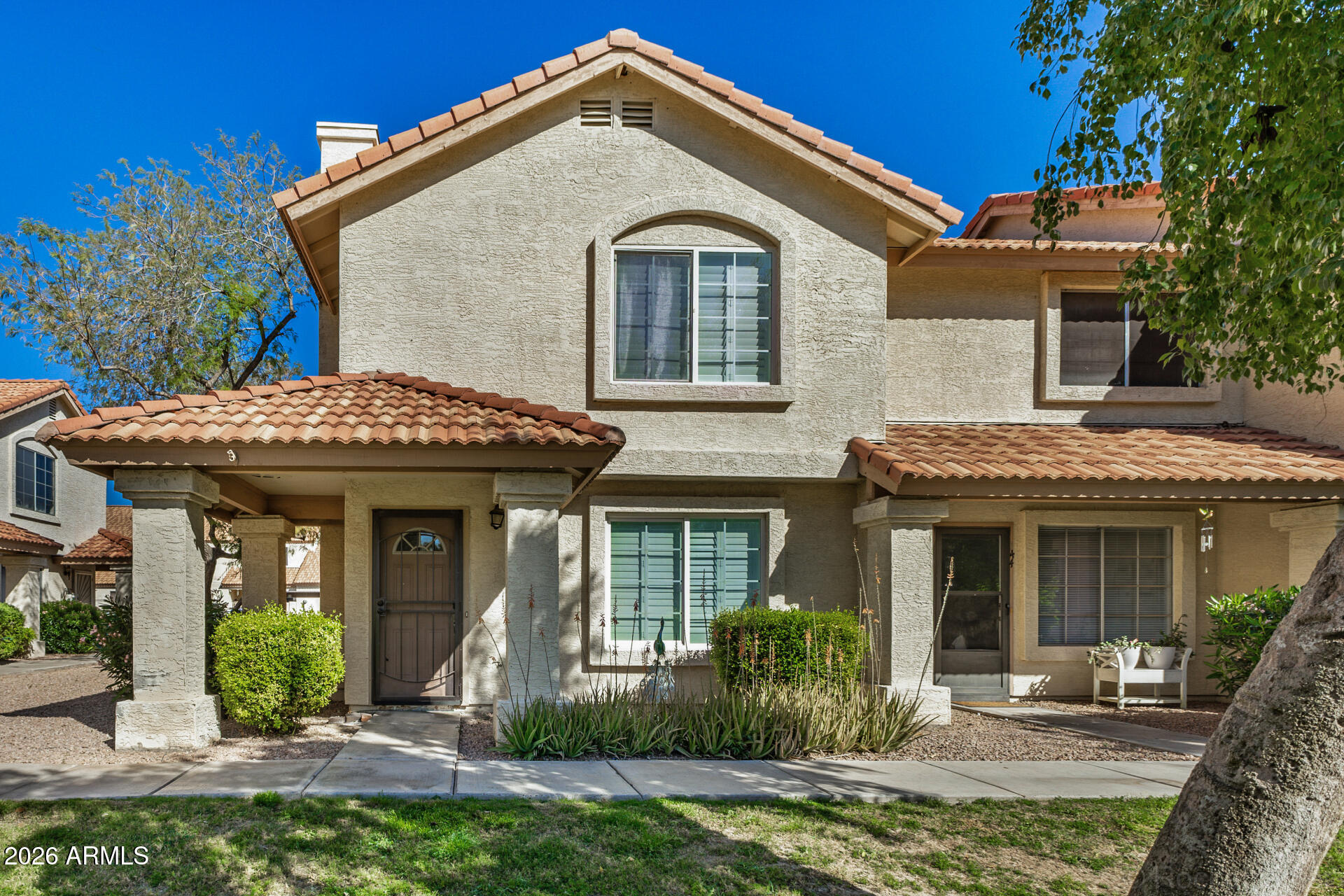 5808 East Brown Road, Unit 143 Mesa, AZ 85205 - Photo 2 of 22 a front view of a house with garden