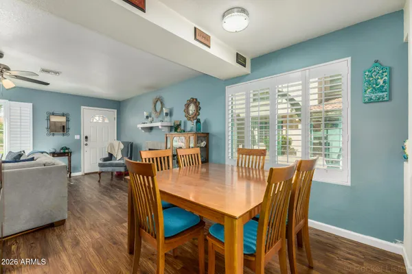 a dining room with furniture and wooden floor