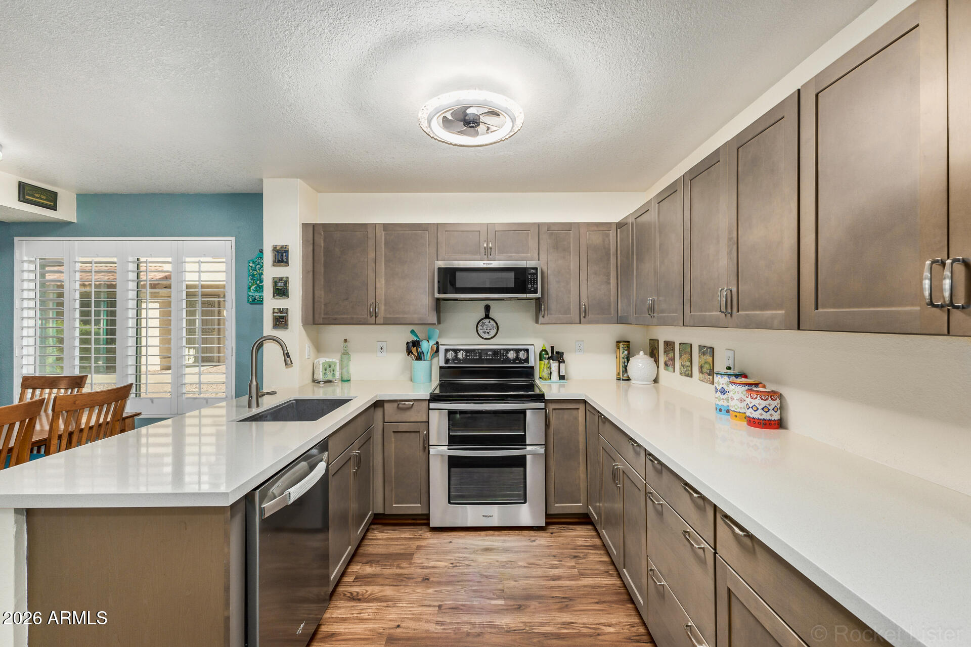 5808 East Brown Road, Unit 143 Mesa, AZ 85205 - Photo 5 of 22 a kitchen with stainless steel appliances granite countertop a stove and a sink