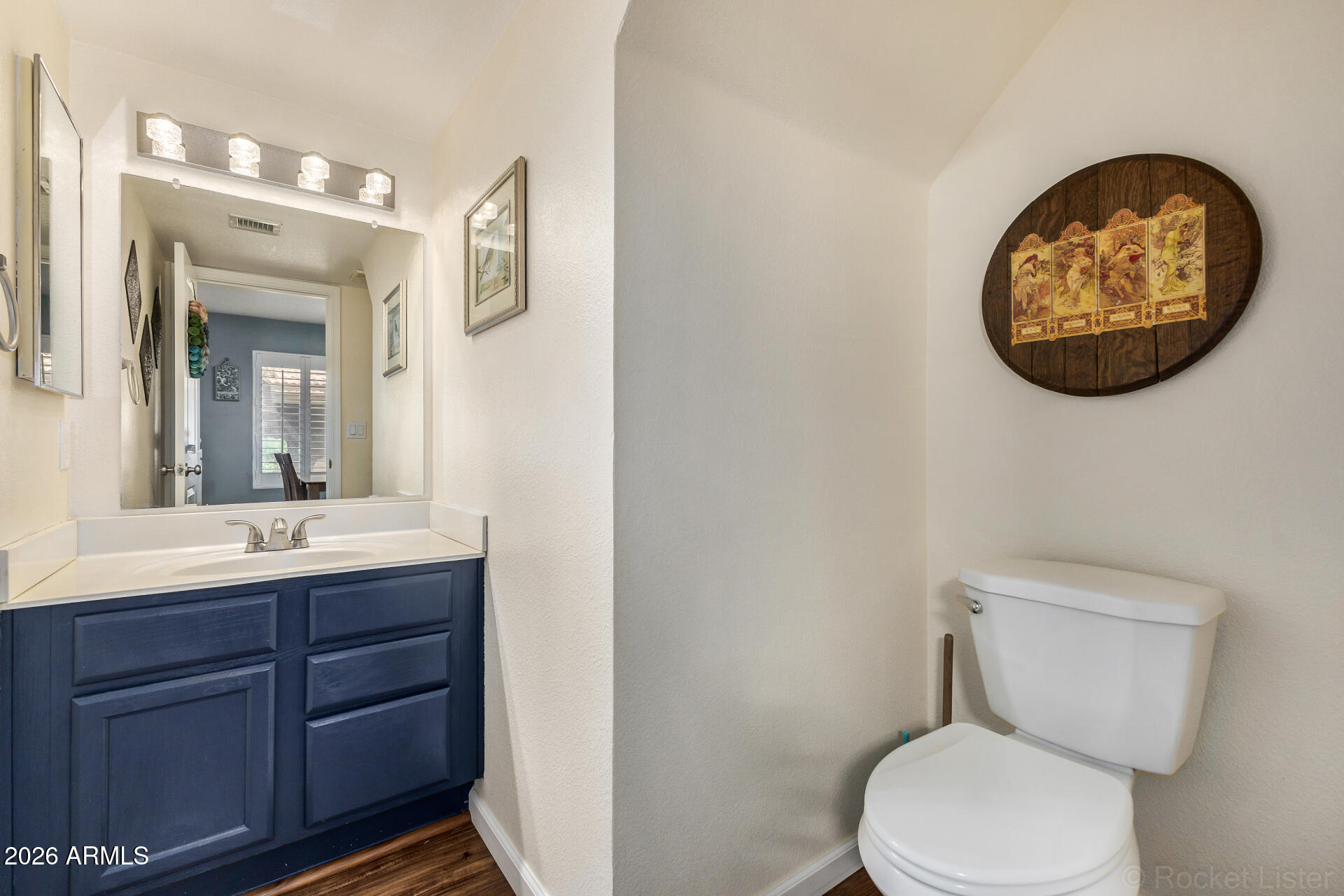 5808 East Brown Road, Unit 143 Mesa, AZ 85205 - Photo 8 of 22 a bathroom with a toilet sink vanity and mirror
