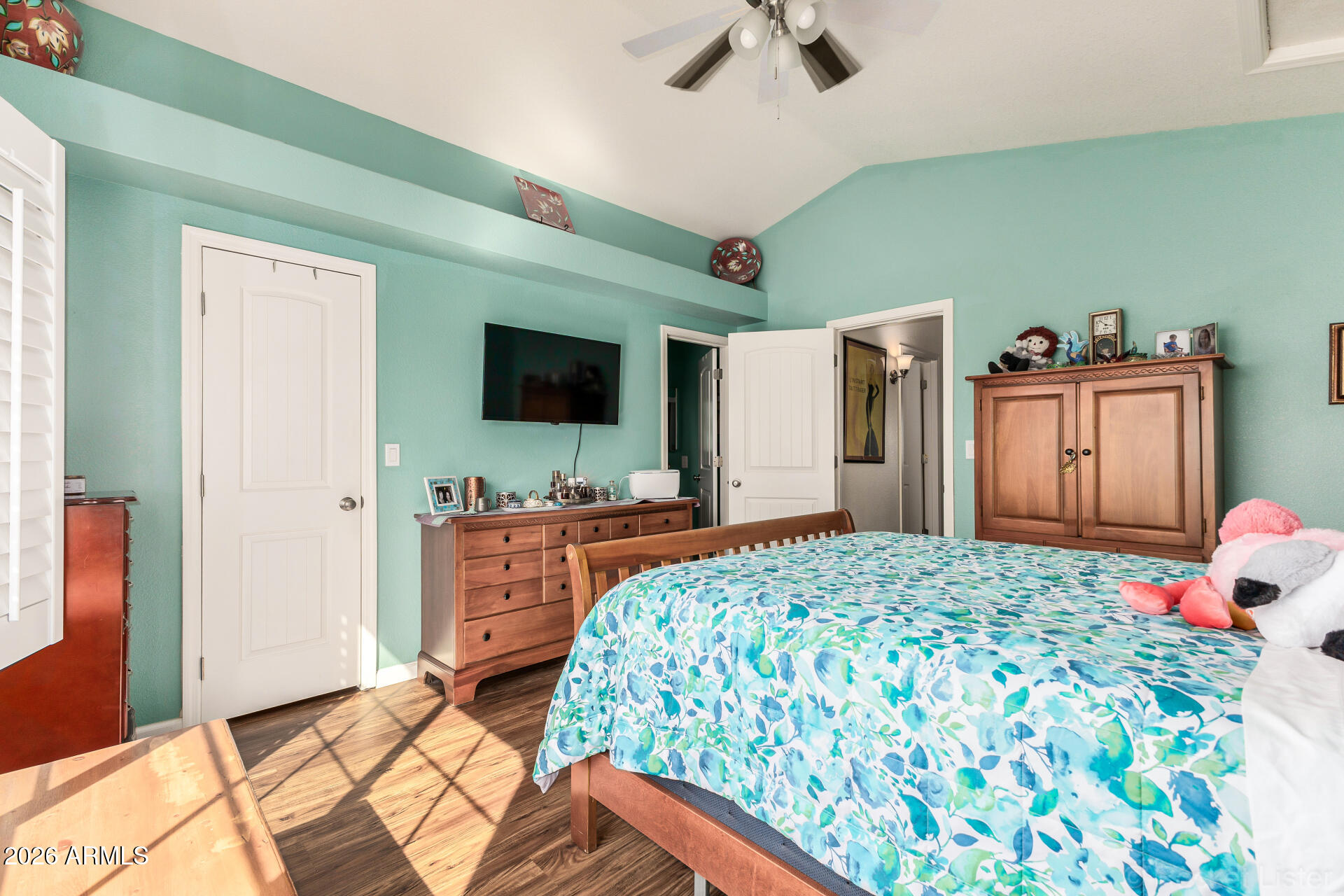 5808 East Brown Road, Unit 143 Mesa, AZ 85205 - Photo 10 of 22 a bedroom with a bed and a flat tv screen on dresser