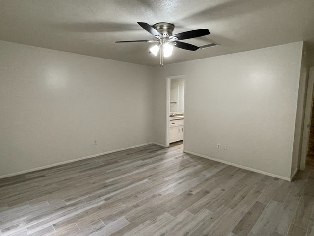 3003 Planters Street Sugar Land, TX 77479 - Photo 11 of 40 a view of an empty room with wooden floor
