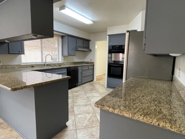 3003 Planters Street Sugar Land, TX 77479 - Photo 14 of 40 a kitchen with stainless steel appliances granite countertop a sink stove and refrigerator