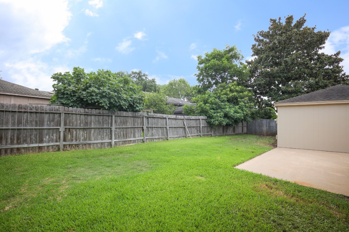 3003 Planters Street Sugar Land, TX 77479 - Photo 19 of 40 a view of a backyard with a garden and trees