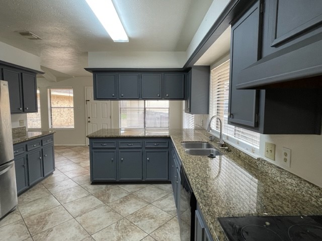 3003 Planters Street Sugar Land, TX 77479 - Photo 3 of 40 a large kitchen with granite countertop a stove a sink and a microwave